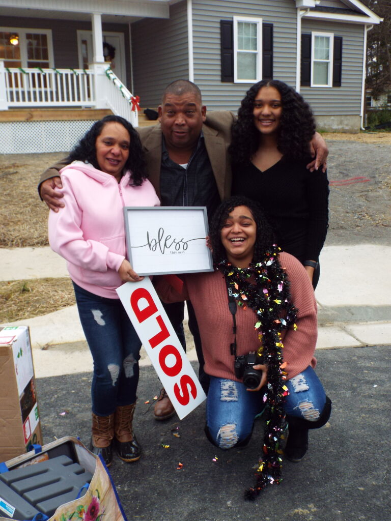 Family of 4 in front of home