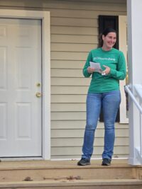 Heather Standing Proud in Front of Her New Home